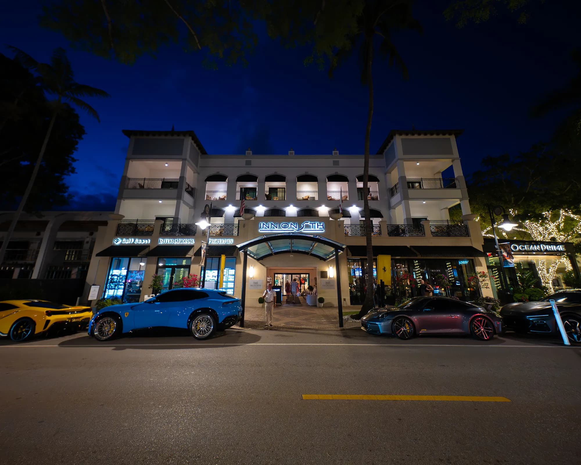 Inn on 5th at night, with supercars parked out front